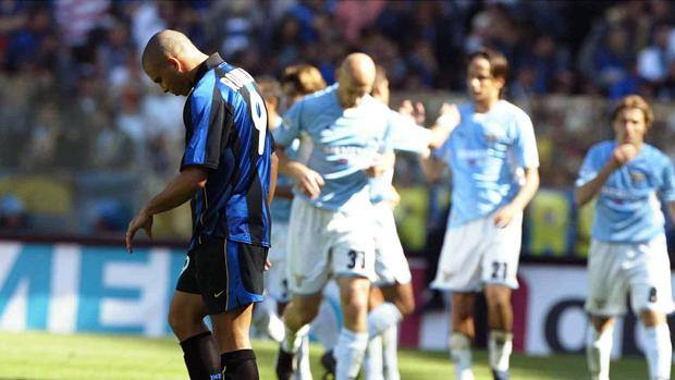 Inter's Ronaldo looks down at the ground as Lazio players celebrate behind him